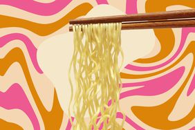 a photo of ramen noodles on chopsticks