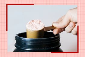a photo of someone taking a scoop of protein powder out of a container